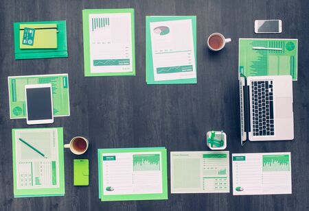 Eco business and ecology office desktop with green reports and accessories, laptops and touch screen...