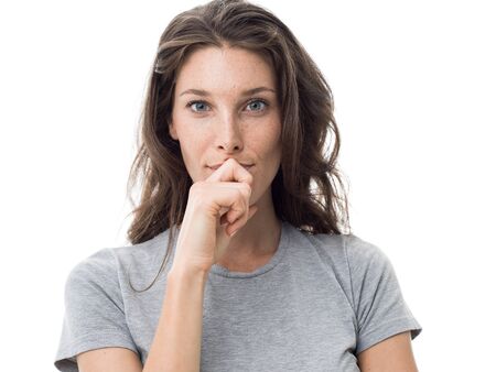 Confident pensive beautiful woman thinking with hand on chin and smiling at camera