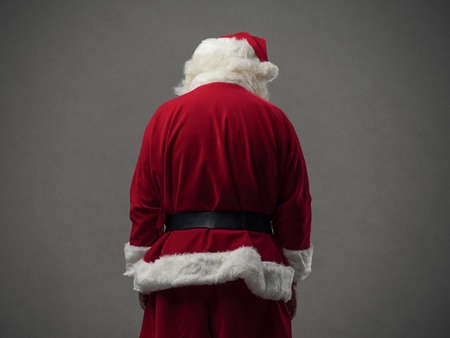 Sad Santa Claus looking down, back view, Christmas and celebrations conceptの写真素材