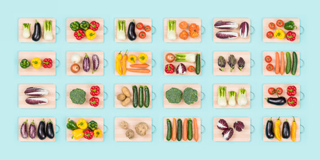 Fresh organic vegetables assortment on wooden chopping boards: healthy eating and vegan food conceptの写真素材