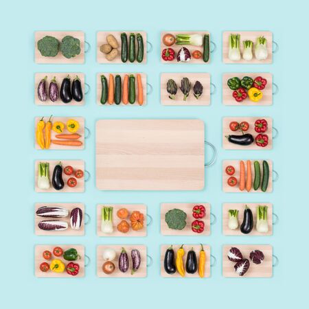 Fresh raw healthy vegetables on wooden chopping boards frame and copy space at center, healthy eating conceptの写真素材