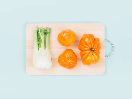 Fresh organic vegetables on a wooden chopping board, food preparation and healthy eating concept