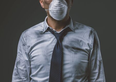 Corporate businessman wearing a protective mask for air pollution, business and environmental care conceptの写真素材