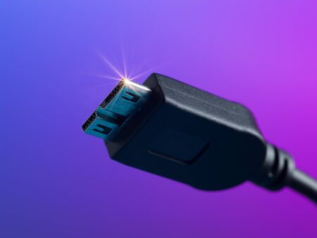 Usb cable plug close up on colorful background