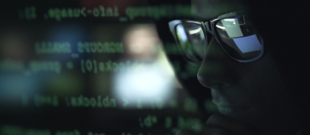 Cool hacker with sunglasses and programming code on the computer screen, cybercrime and hacking...