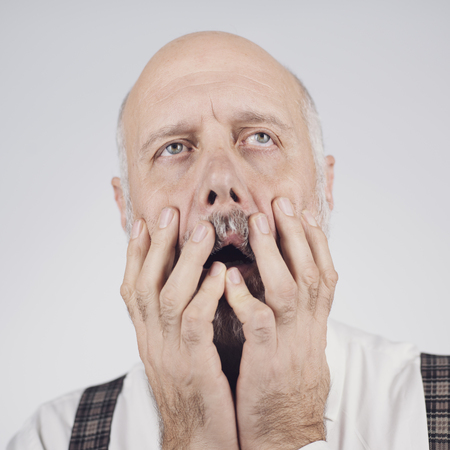 Frustrated mature man, he is feeling exhausted and desperate, feelings and emotions conceptの写真素材