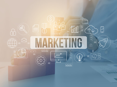 Business executive building a successful growing chart with wooden blocks, flowchart with business and financial icons, successful marketing strategies conceptの写真素材