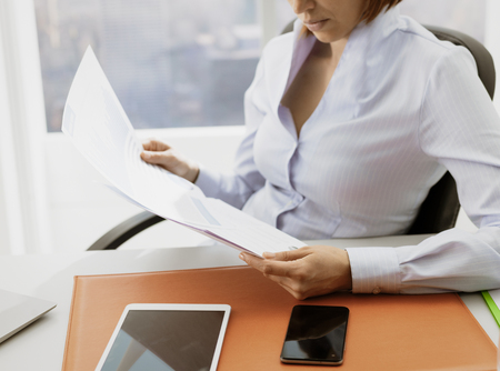 Business executive checking financial reports and working in the office, accounting and business management conceptの写真素材