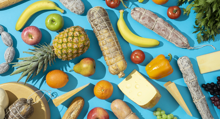 Fresh grocery shopping products background: vegetables, fruit, cured meat and cheeseの写真素材