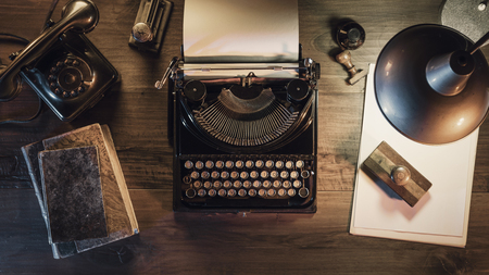 Vintage journalist desktop with typewriter and retro lamp, 1950s style, flat lay desktopの写真素材