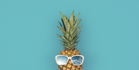 Funny fresh pineapple wearing sunglasses, summer fun conceptの写真素材