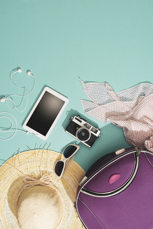 Packing and leaving for summer vacations: bag, straw hat, camera and accessories flat lay, blank copy spaceの写真素材