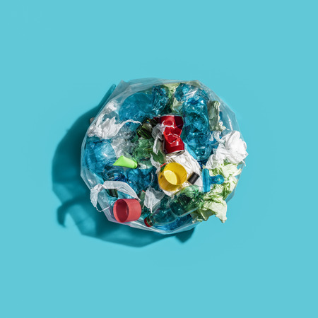 Open garbage bag filled with plastic and other mixed trash, separate waste collection and recycling conceptの写真素材