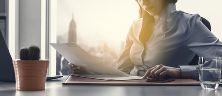 Business executive checking financial reports and working in the office, accounting and business management conceptの写真素材
