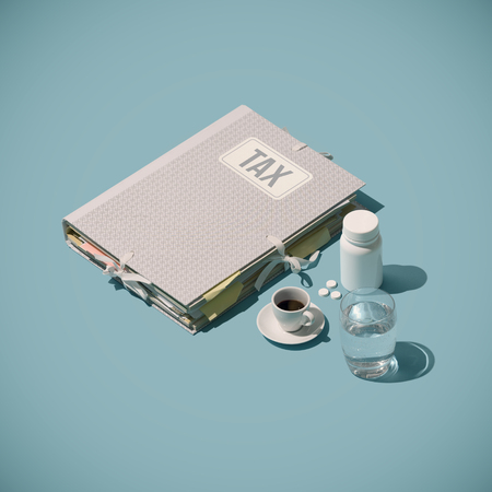 Tax-time stress: folder with tax forms, coffee and calming pillsの写真素材