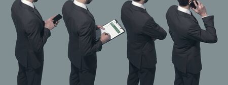 Corporate business people standing together in line, they are using smartphones and checking business reports: human resources and finance conceptの写真素材