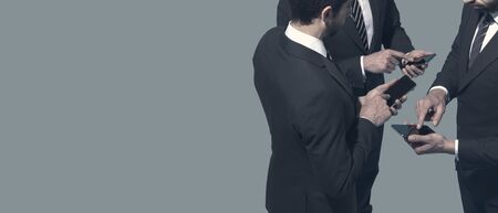 Corporate business people meeting and using their smartphones, communication and technology concept, blank copy spaceの写真素材