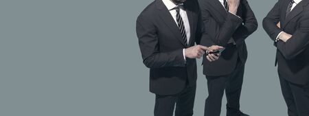 Corporate business people meeting and using their smartphones, communication and technology concept, blank copy spaceの写真素材