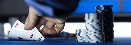Hold 'em Texas poker tournament at casino: a player is holding two ace cards
