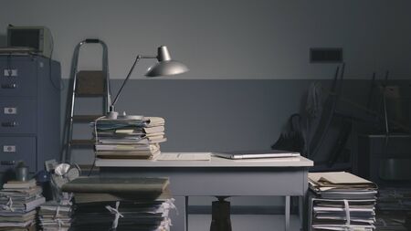 Vintage style office with lots of paperwork and furnishingsの写真素材