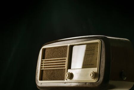 Vintage radio with knobs on black background, entertainment and audio conceptの写真素材