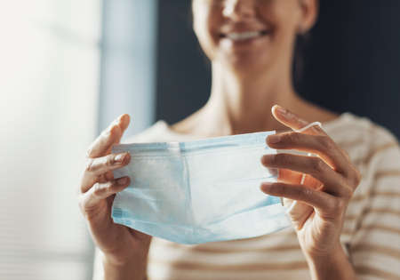 Woman wearing a protective surgical mask, coronavirus covid-19 prevention