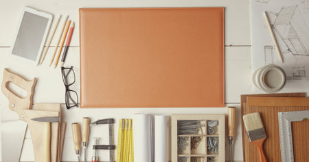 Creative designer and carpenter desk with DIY tools and project, top view