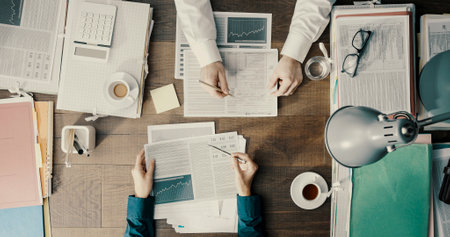 Business people working together and checking financial charts, top viewの写真素材