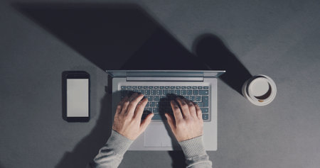 Corporate businessman working on a minimalistic empty desktopの写真素材