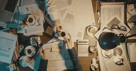 Business people working late at night in the office, deadlines and overtime work conceptの写真素材