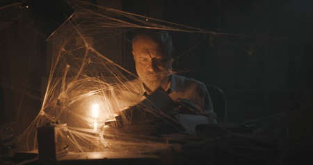 Corporate businessman searching for paperwork in an abandoned office: failure, financial crisis and outdated business conceptの写真素材