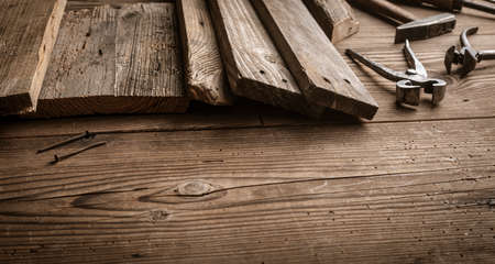 Rustic wooden boards and old tools on the carpenter tableの写真素材