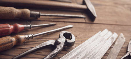 Professional vintage carpentry tools on a rustic wooden table, woodwork and DIY concept, blank copy spaceの写真素材