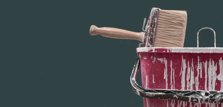 Brush and bucket with paint drops: home renovation and decoration conceptの写真素材