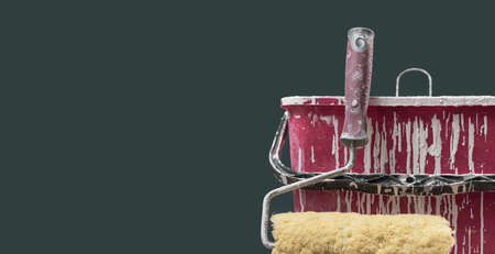 Paint roller and bucket with paint drops: painting and home renovation concept