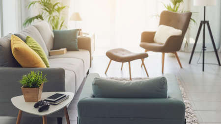 Contemporary living room interior with warm sunlightの写真素材