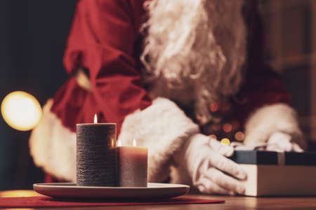Santa Claus delivering Christmas gifts at home, holidays and celebrations conceptの写真素材