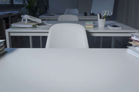 Corporate office interior and desk close up with blank copy spaceの写真素材