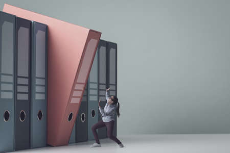 Huge ring binder falling over a tiny woman, she is scared and she is trying to protect herself