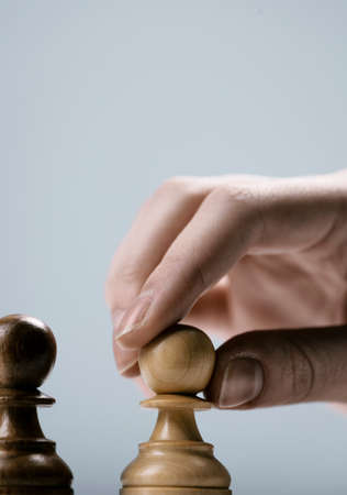 Professional player moving a pawn on the chessboard, chess game and strategy conceptの写真素材