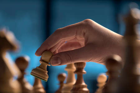 Professional player moving a pawn on the chessboard, strategy games conceptの写真素材
