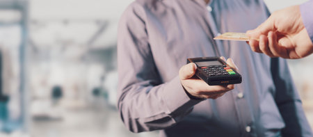 Customer paying with a contactless credit card, electronic payments concept