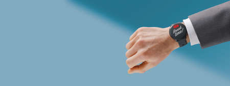 Businessman showing a smart watch with low battery notification, he needs a breakの写真素材