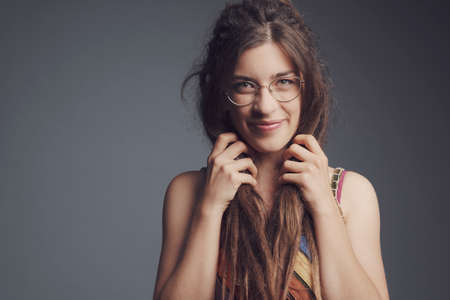 Closeup portrait of young beautiful woman with piercing, dreadlocks and long hairï¿¼