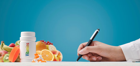 Dietician writing a diet plan and prescribing vitamins, diet and nutrition conceptの写真素材