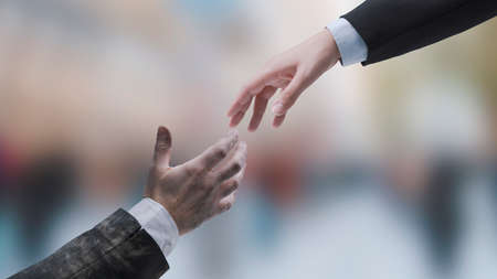 Businessman giving a handshake to a failed jobless business executive: get help and support for your...