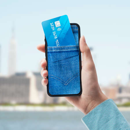Jeans pocket on a smartphone display with credit card inside, mobile payments and online banking...