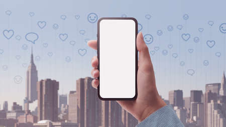 Woman holding a smartphone and using social media online, city skyline in the background, POV shot