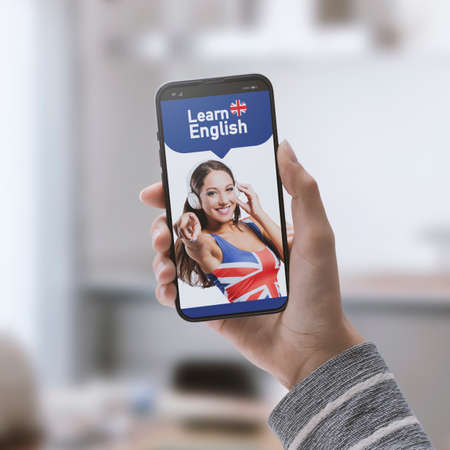 Hand holding a smartphone and English learning app on the phone screen, online learning concept