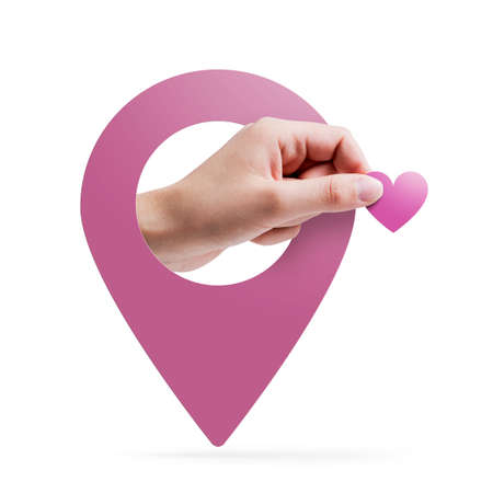 Hand holding a heart and location pin: online dating concept On white backgroundの写真素材